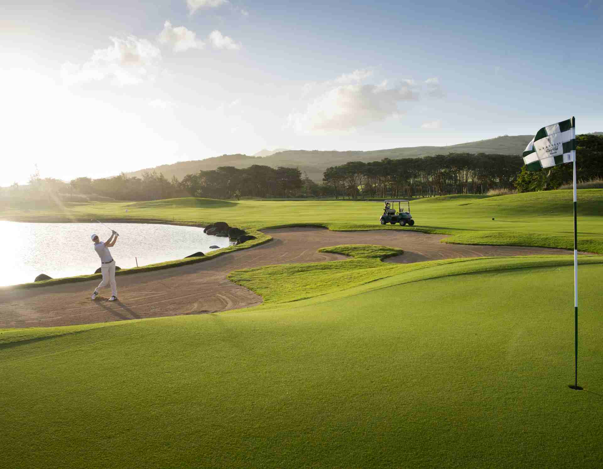 Golfer swinging a club on the fairway of Le Chateau Golf Course in Mauritius